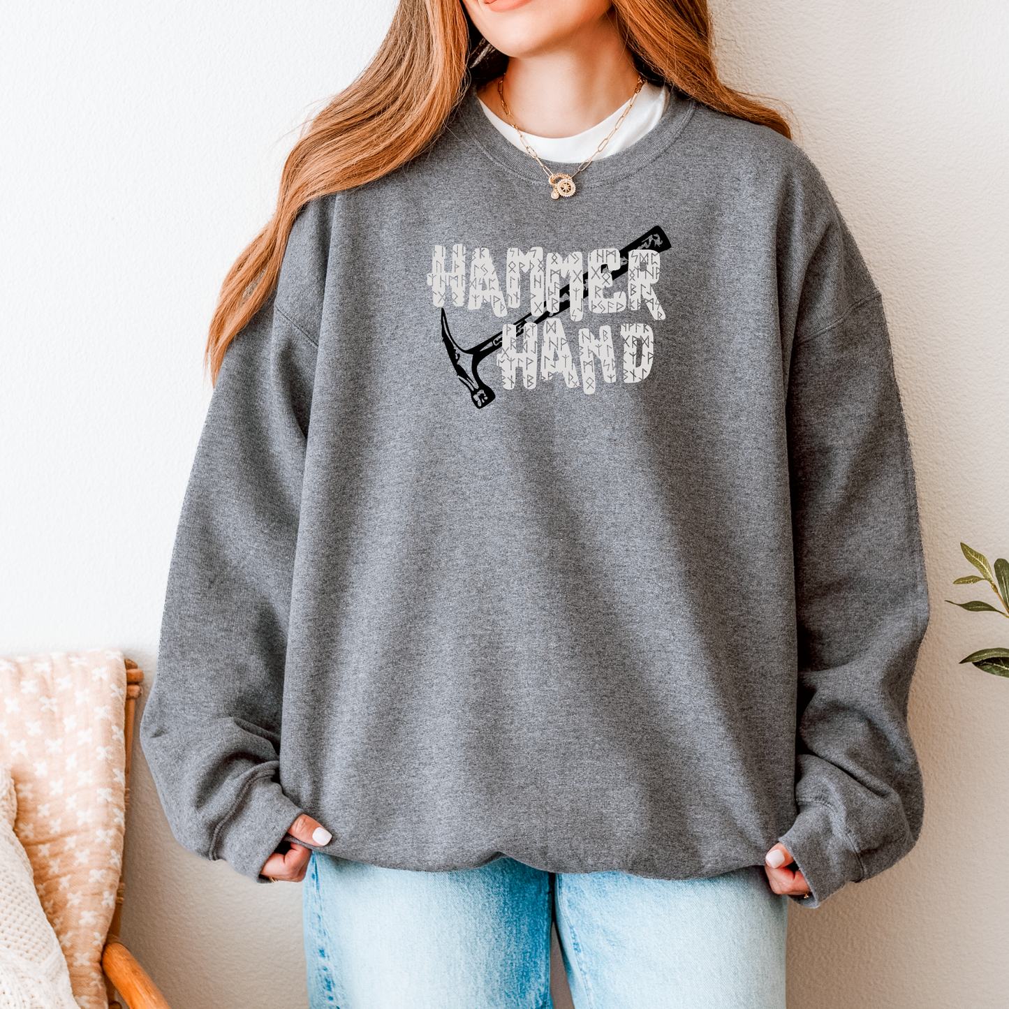 Person wearing a gray sweatshirt with 'HAMMER HAND' text and graphic, standing against a neutral background.