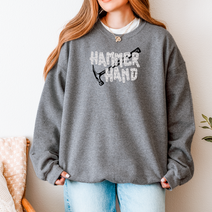 Person wearing a gray sweatshirt with 'HAMMER HAND' text and graphic, standing against a neutral background.