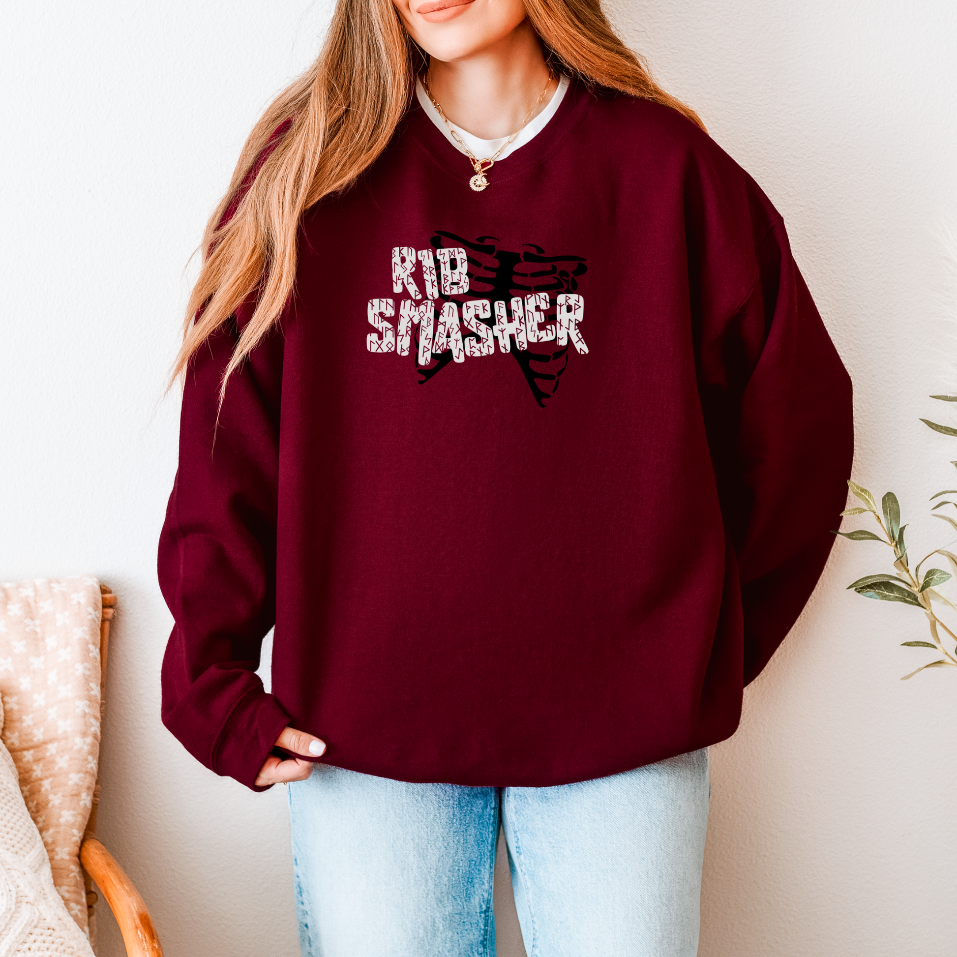 Person wearing a maroon sweatshirt with 'Rib Smasher' text and graphic, standing against a neutral background.