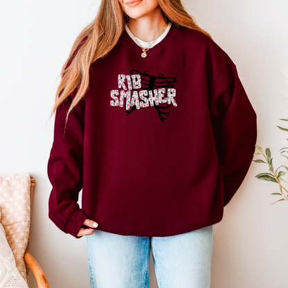 Person wearing a maroon sweatshirt with 'Rib Smasher' text and graphic, standing against a neutral background.