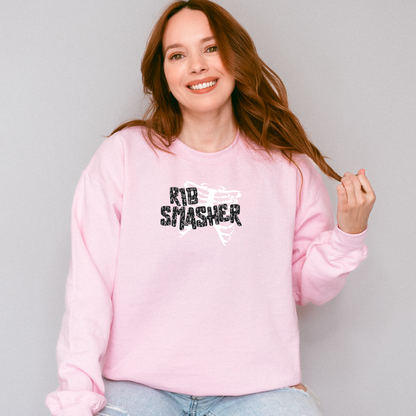 Woman wearing a pink sweatshirt with 'KID SMASHER' text, standing against a plain background