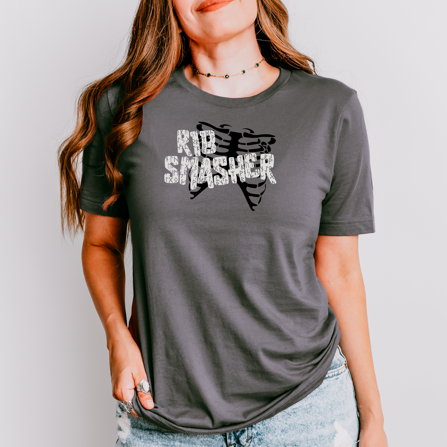 Person wearing a gray t-shirt with 'KID SMASHER' text and graphic design.