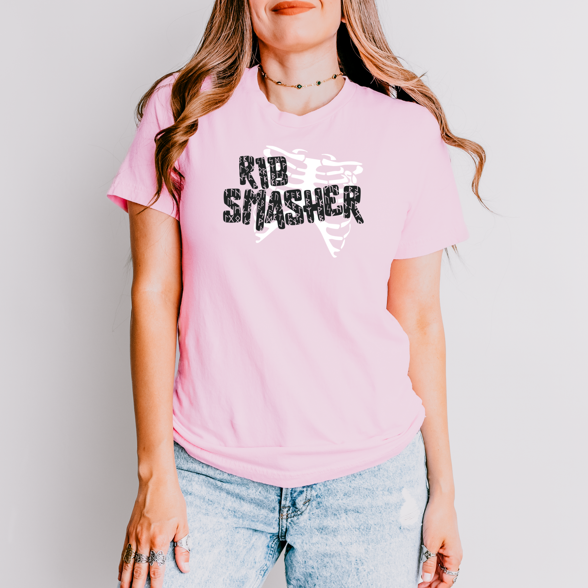Person wearing a pink t-shirt with 'Rib Smasher' text against a plain background