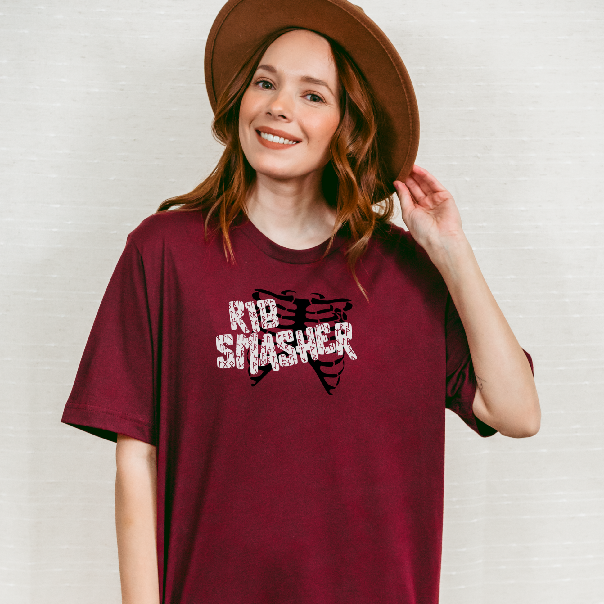 Woman wearing a maroon t-shirt with 'K1B Smasher' design against a white background