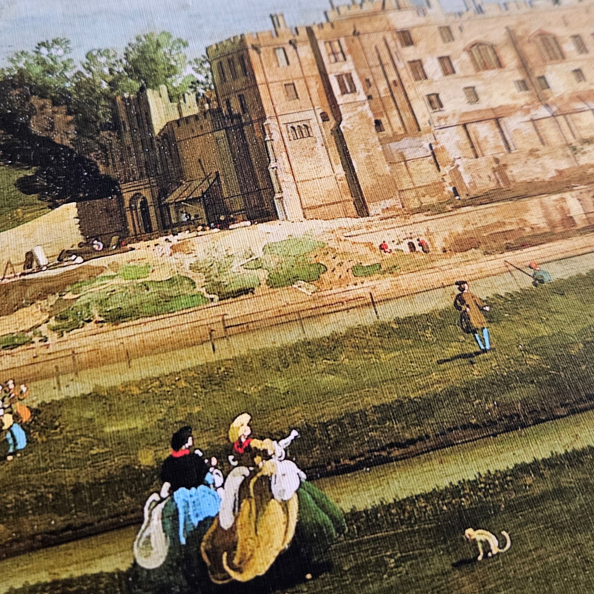 A vintage-style painting or print depicting a grand stone palace or castle beside a river, with small figures of people and animals in the foreground.