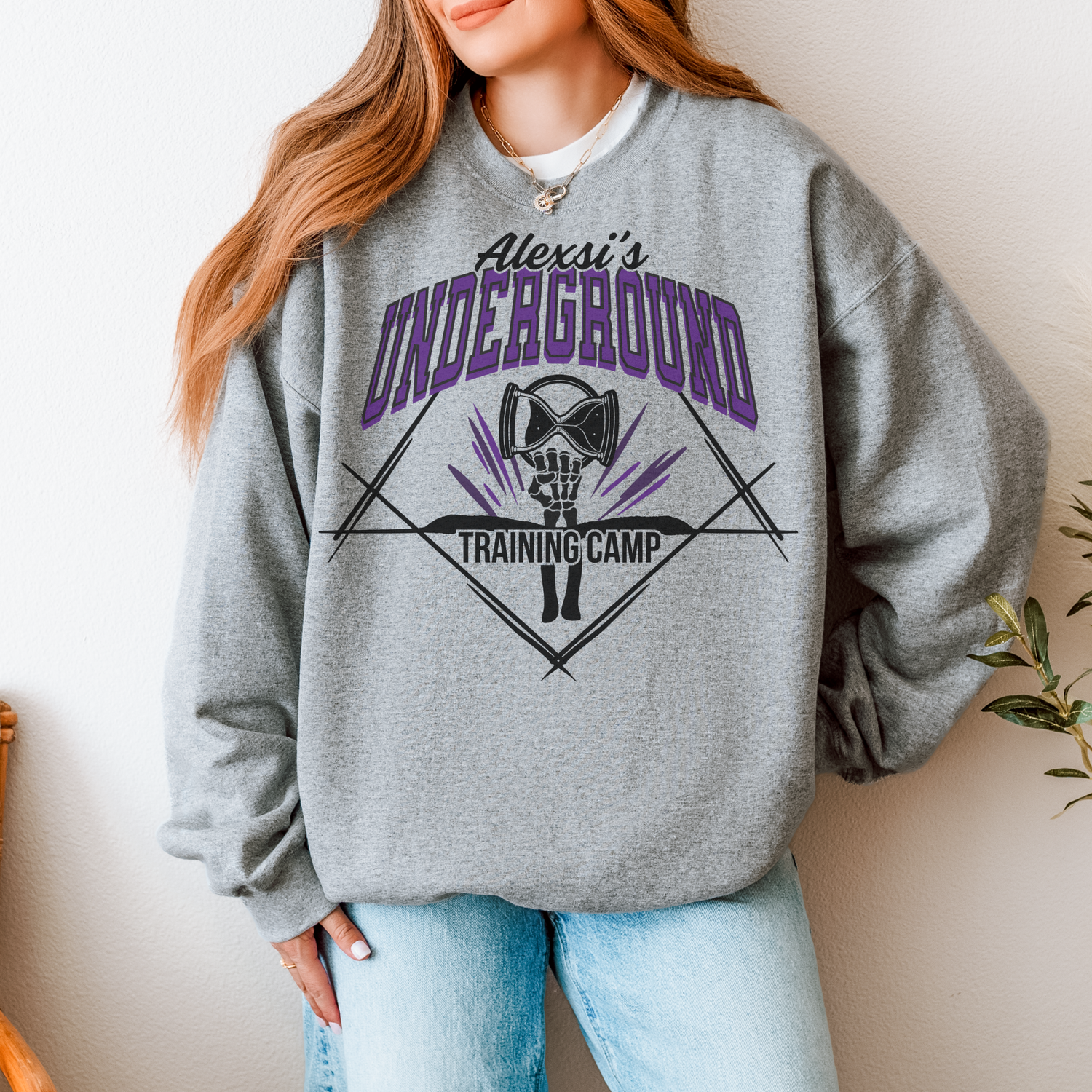 model in grey sweatshirt with alexsi's underground training camp design